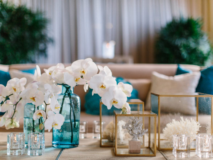 white orchids, coral reef, candles, gold box, teal pillows, beach, nautical, couch, green plants, wedding decor, la wedding planner