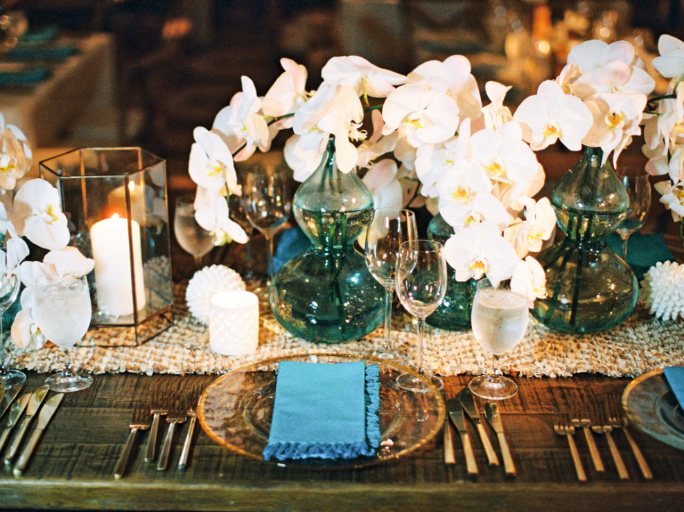 blue flower vase, blue napkins, silverware, white orchids, fresh flowers, candles, party decor, nautical