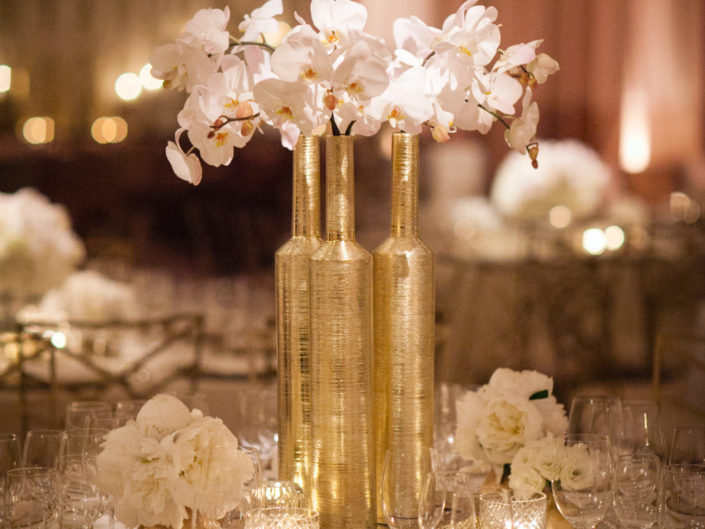 gold vase, white orchids, floral arrangement, gold accents, coco chanel, gucci, celebrity event planners