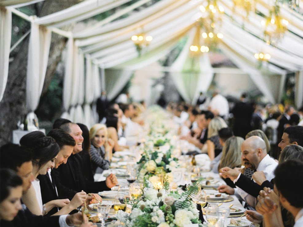 tables cape dinner decor, white and cream florals and chuppah, luxe wedding, black and white accents, wedding guests, glassware, white black and gold decor, greenery accents, kristin banta weddings and special events, los angeles event planner