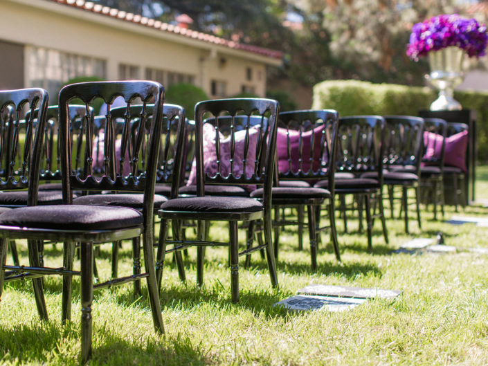outdoor wedding ceremony, warner brothers wedding, black and purple color accents, black wooden chairs, purple floral accents, damask aisle decor, weddings and special events, kristin banta, los angeles event planner