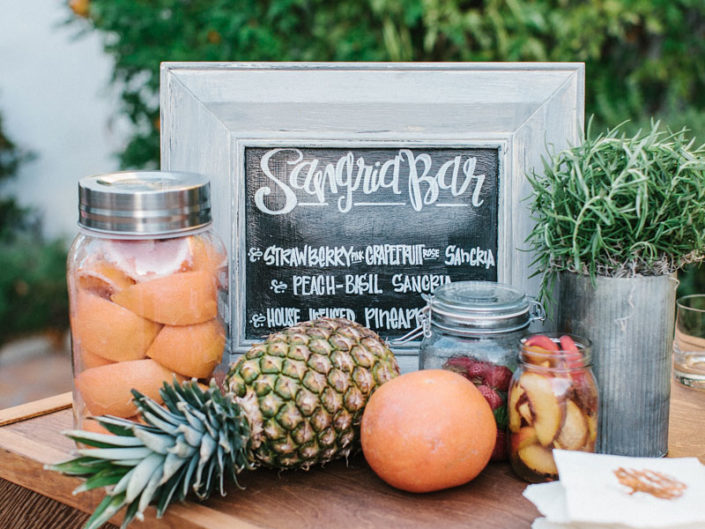 sangria bar, bar decor, market-style design, fruit embellished decor, greenery, los angeles event planner, kristin banta wedding design