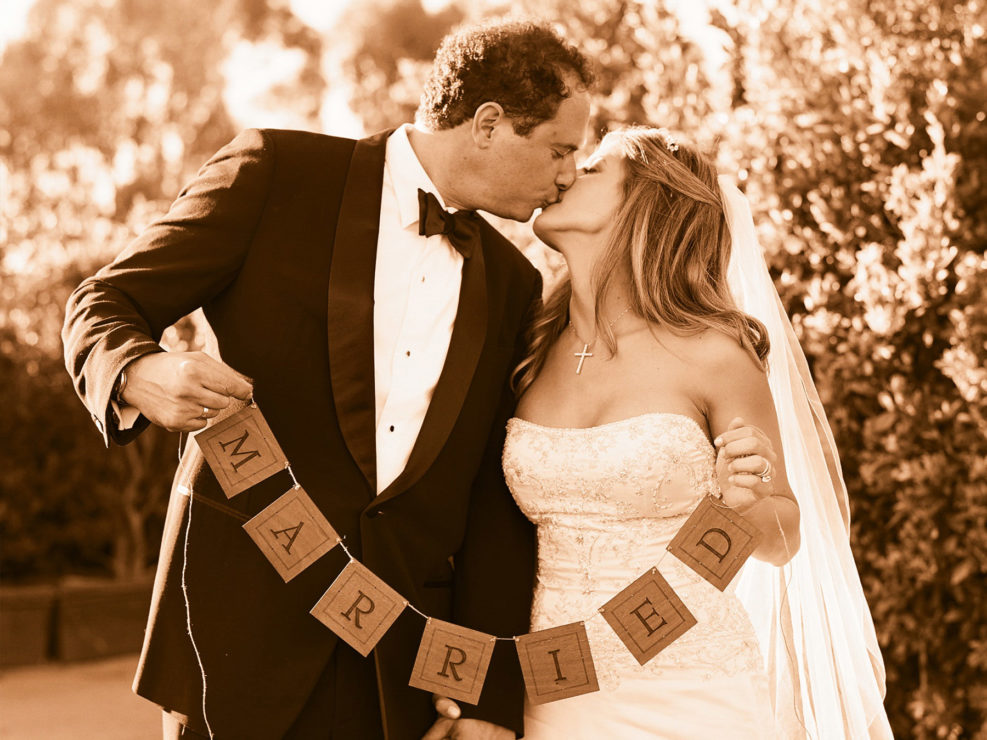 Wedding Photography, sepia photography, religious wedding, kissing, married sign, wedding dress, tuxedo, bow tie, newlyweds, couple, kristin banta events