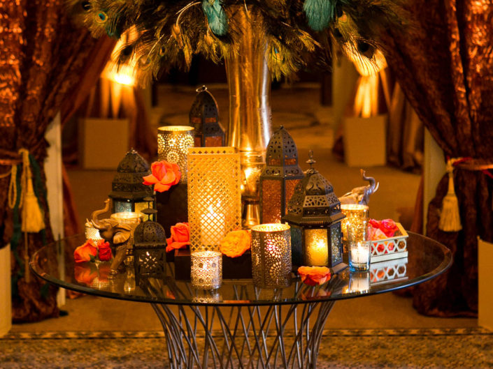 multifaceted gilded vases, gold moroccan lanterns, dim lighting design, table top decor, moroccan inspired engagement party, foyer, peacock feather centerpiece, LA event planner, kristin banta