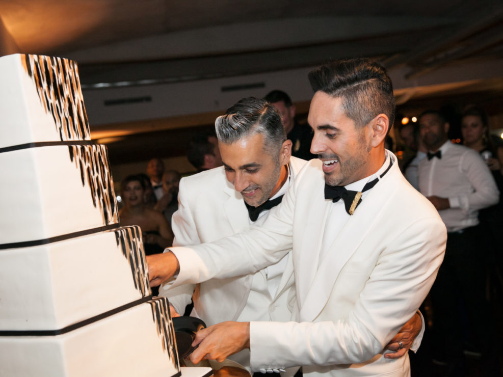 Gay Wedding, Wedding Photography, Cutting of the cake, Black and gold accents, wedding decor, wedding cake, Luxe Wedding, white suits, Alexandria Ballrooms, Produced by Kristin Banta Events